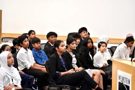 A student presenting a forensic-science case study on screen to a small group