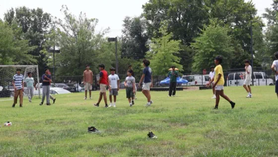 A group of students playing together on an open field