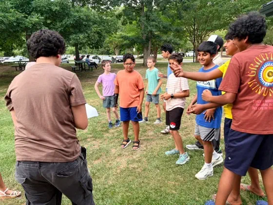A group of students playing a game together outdoors