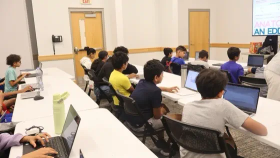 Students seated at laptops during a workshop session