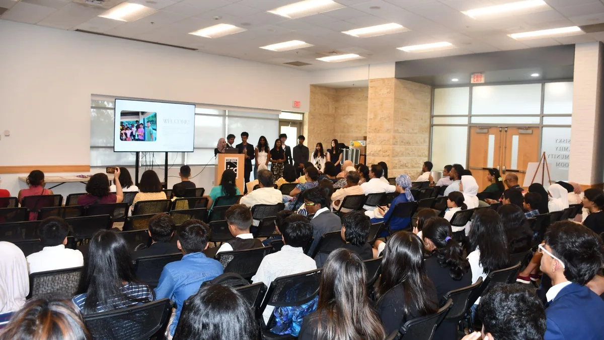 Students seated in an auditorium during a FutureVitals Research Academy session