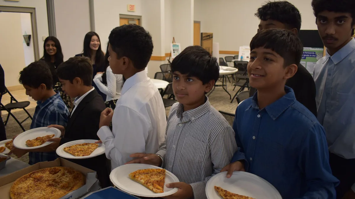 Students eating lunch together during the Research Academy