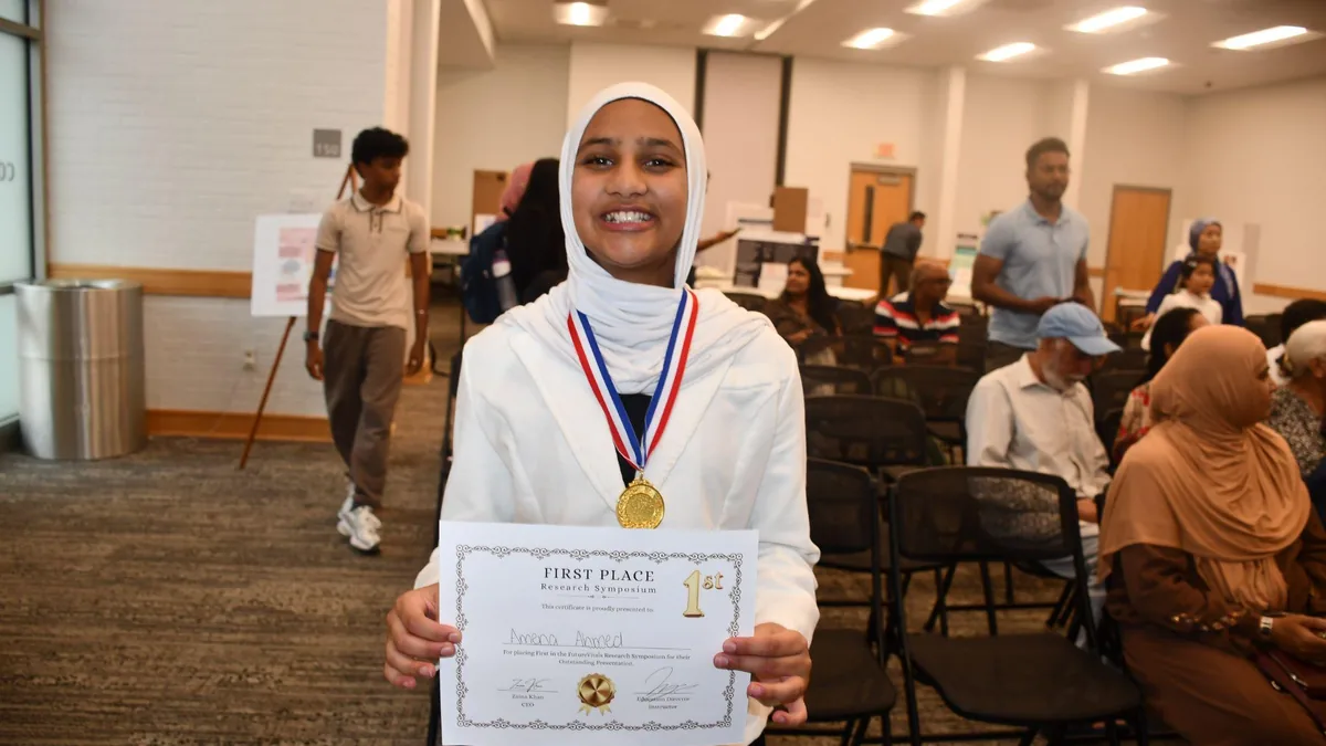 A student receiving a medal at the awards ceremony