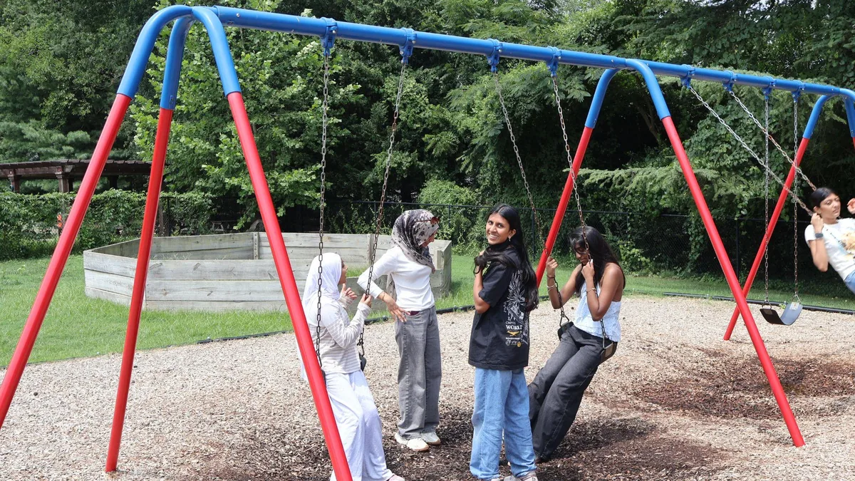 Students on the swings during outdoor time