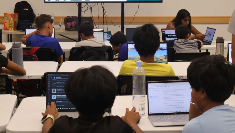 A mentor presenting to students at the front of the room