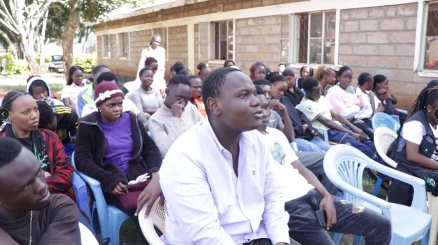 A community gathering listening to a speaker during FutureVitals outreach in Kenya