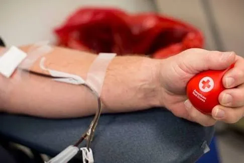 A blood donation in progress at a community drive