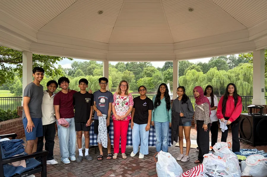 The clothing drive team together at the end of a sorting session