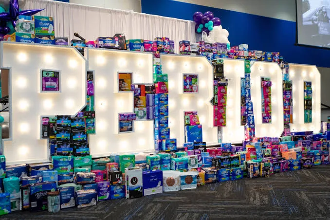 Collected period products arranged to spell the word PERIOD