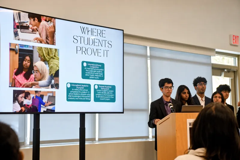 FutureVitals students presenting research opportunities at a symposium