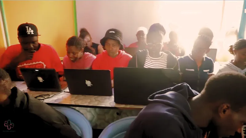 Students working at laptops during a FutureVitals STEM session in Kenya