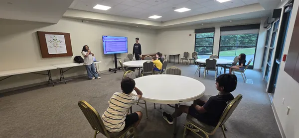 Students listening to the bioinformatics workshop from their table