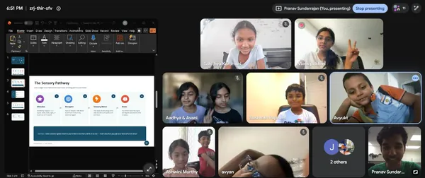 Campers on camera while a lesson slide on the sensory pathway is presented