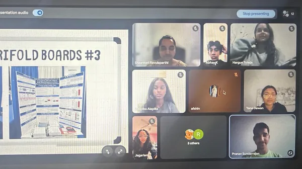 Volunteers walking students through sample trifold boards on a video call